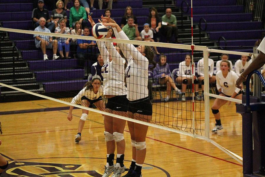 Seniors Danielle Mollerus and Lauren Dwyer block the ball to earn a point against the Barstow Knights.