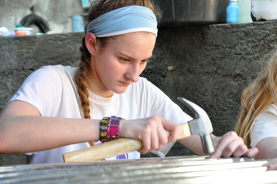 Alumna Maddie Young '18 nails the roof onto the chicken coop March 15, 2018 during the service trip to San Andrés Itzapa, Guatemala. 