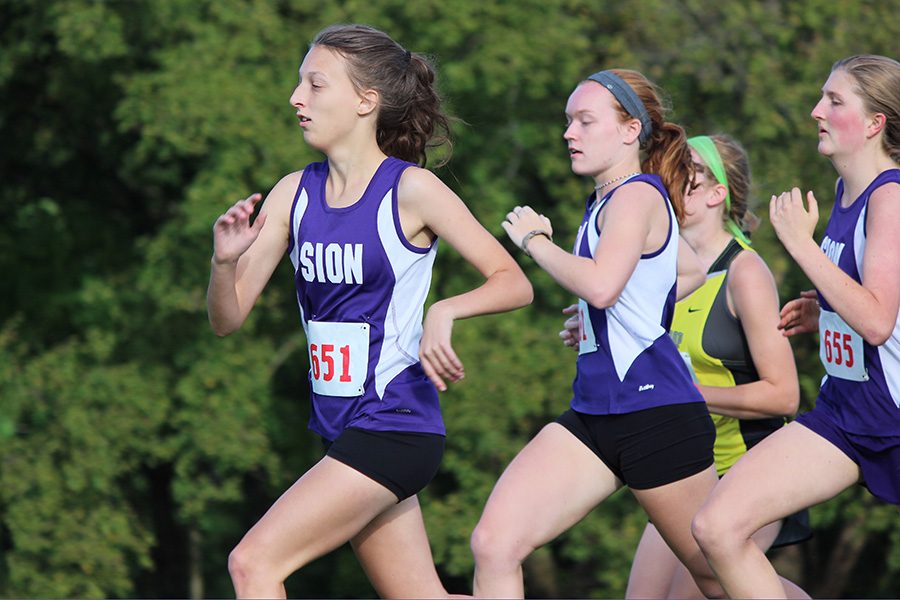 Seniors Abby Englert, Nora Malone and Honor Schleicher take the first strides
of the Junior Varsity race at Stocksdale Park in Liberty.