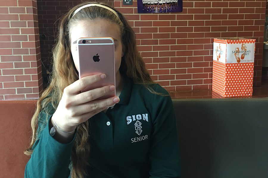 Senior Geneva Sinkula spends time on her iPhone 6 during her study hall.