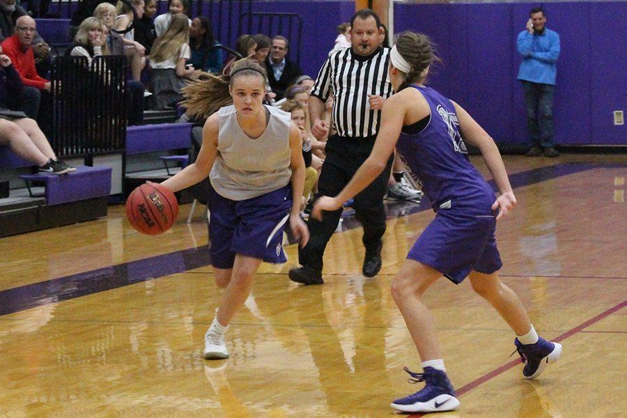 Freshman Lacy Whitcomb runs down court against senior Madeline Dercher.