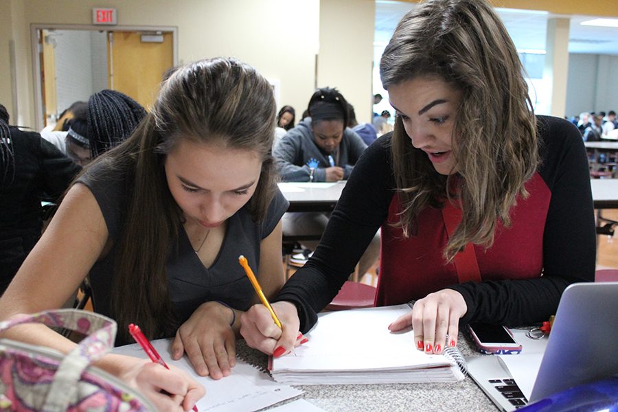 Juniors Melissa Hamilton and Tierney Manning work on their arguments for their debate.