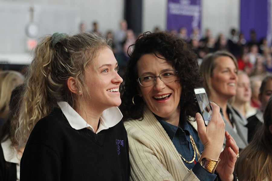 Junior Emilie Connors and her mother laugh before the start of the Mass. 