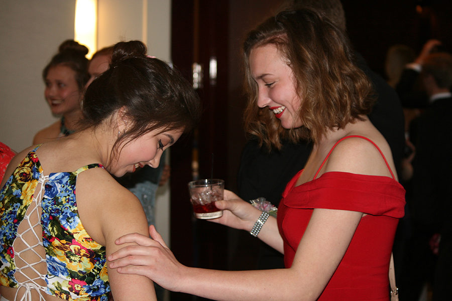 Seniors Maria Arroyo and Maddi McMaster compliment each others' dresses.