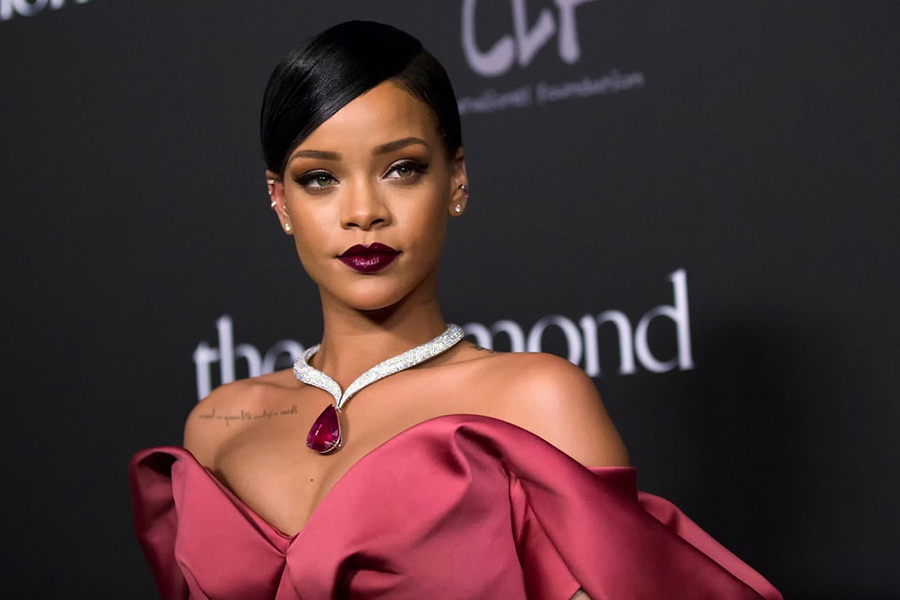 Singer Rihanna poses for a picture while on a red carpet.