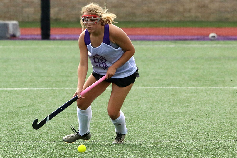 During the annual Purple vs White scrimmage on August 29, Freshman Hannah McGraw dribbles up the field for the white team.