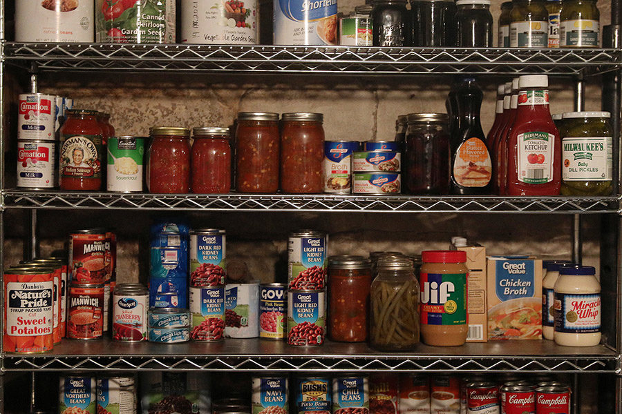 Canned goods and other non-perishable food items line the shelves.