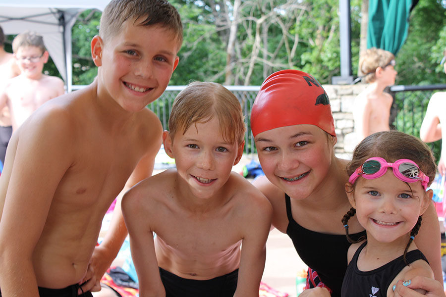 Grojean poses for a picture with siblings Dylan Grojean, Tyler Grojean and Ava Grojean during a swim meet this summer.