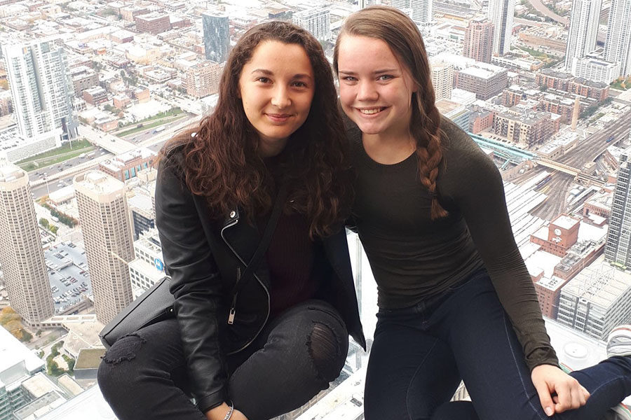 Junior Liz Oltjen and French exchange student Caroline Escudero posed for a picture at the top of Skydeck Chicago in Sears Tower Oct 27. 