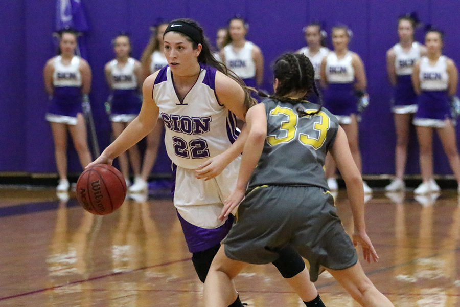 Senior co-captain Sarah Totta looks inside as she dribbles down the court in the first half of the basketball game against St. Teresa's Academy Nov. 17. 