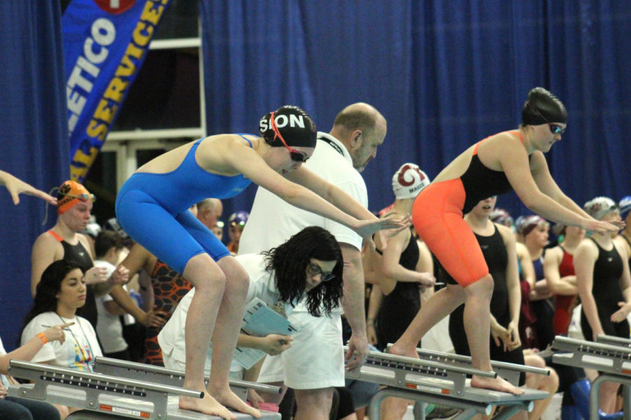 During the State competition Feb. 17, 2017, sophomore Bridget Schumm is ready to take dive off the starting block to swim in a team relay. 