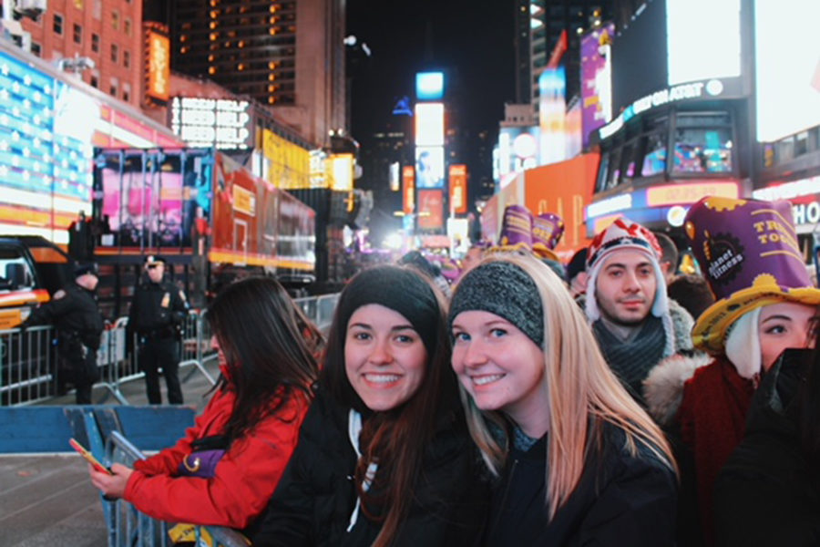 Senior Anna Tomka and Australia exchange student Alisha Centrone pose for a picture while waiting for the ball to drop on New Year’s Eve.