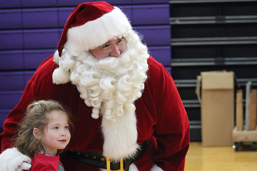   Director of Facilities and Operations Andy Sheer poses with lower school girl at the annual Breakfast With Santa Dec. 2.