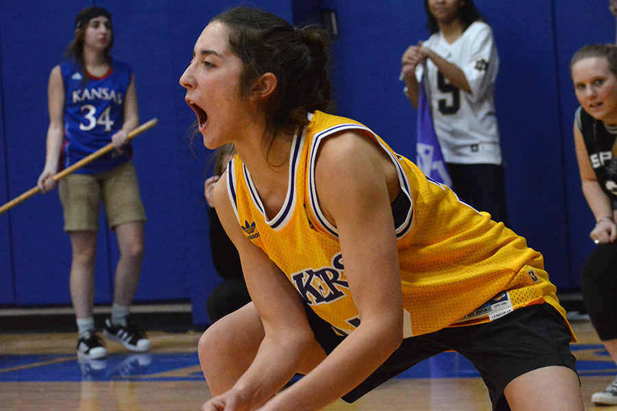 Senior Mary Evans screams while cheering on the volleyabll team in the third set against Rockhurst High School Feb. 5.