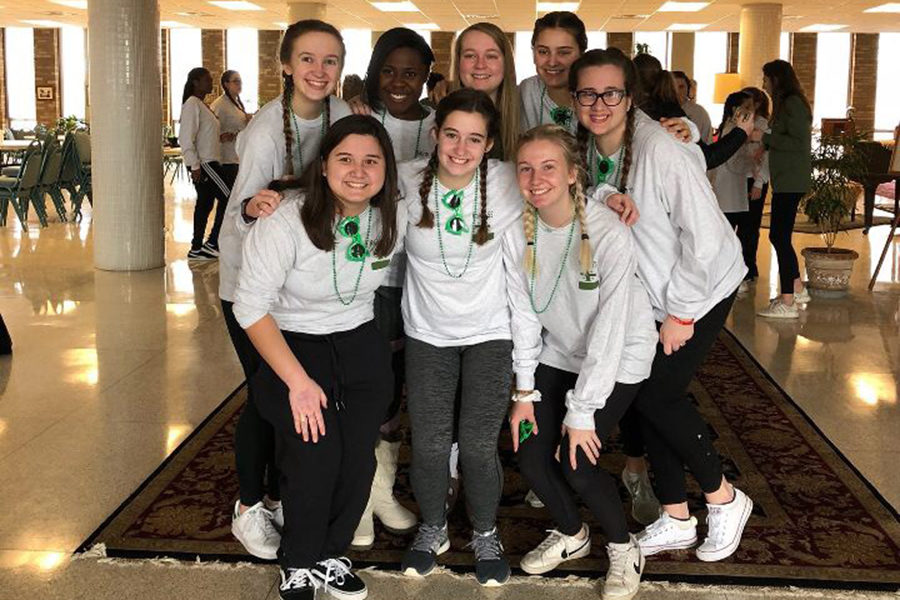 Senior Anna Tomka and other Kairos 55 retreatants pose for a picture with their leader on the morning of the last day before leaving Atchison, Kansas.