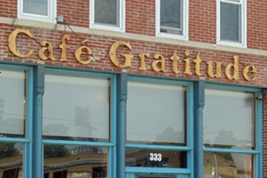 The outside of the reatraunt, with vintage lettering on a brick exterior.