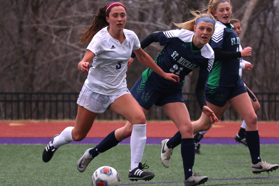 During a game last season, senior Meghan Frerking prepares to pass the ball in the first half of the soccer game against St. Michael the Archangel March 20, 2018.