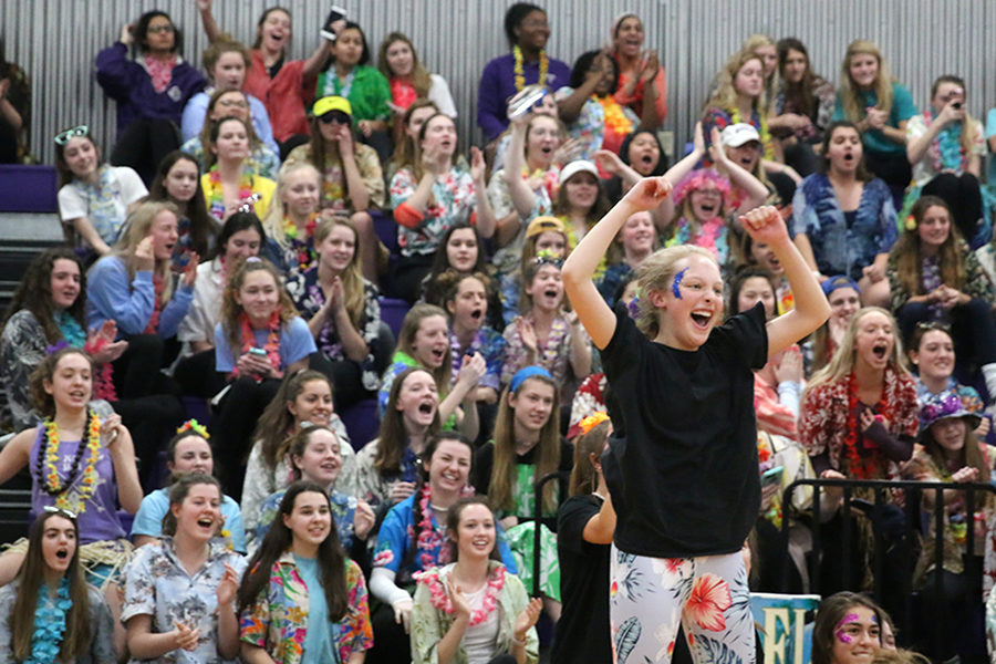 While watching four members from each grade compete in tug-of-war for Sion Olympics March 2, dressed in her grade’s theme of the country Fiji sophomore Brie Bows celebrates in front of the student section as the sophomores compete.