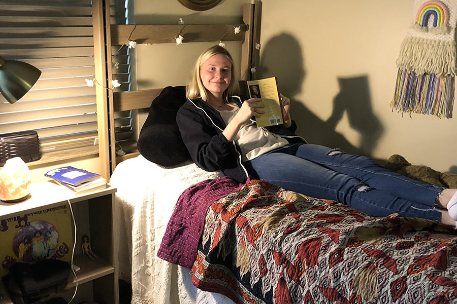 Senior Anna Tomka reads “Beloved” by Toni Morrison while on a dorm room bed in Columbia, Missouri, as the farthest she went this Spring Break was The University of Missouri.