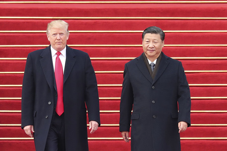 Chinese President Xi Jinping, right, holds a grand ceremony to welcome U.S. President Donald Trump at the square outside the east gate of the Great Hall of the People in Beijing, capital of China, Nov. 9, 2017.