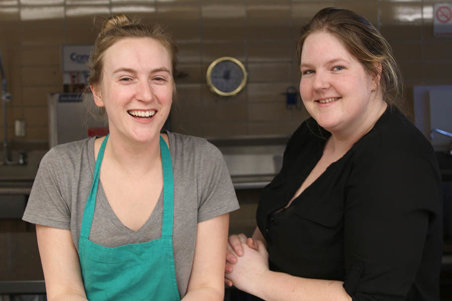 Lunch ladies Amber Davis and Anna Paradise pose together after serving lunch in the school cafeteria.