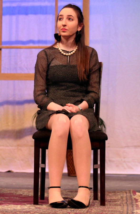 Senior Emily Bello looks off into the distance while zoning out in the middle of a conversation in the play “The Odd Couple” performed on April 19-20.