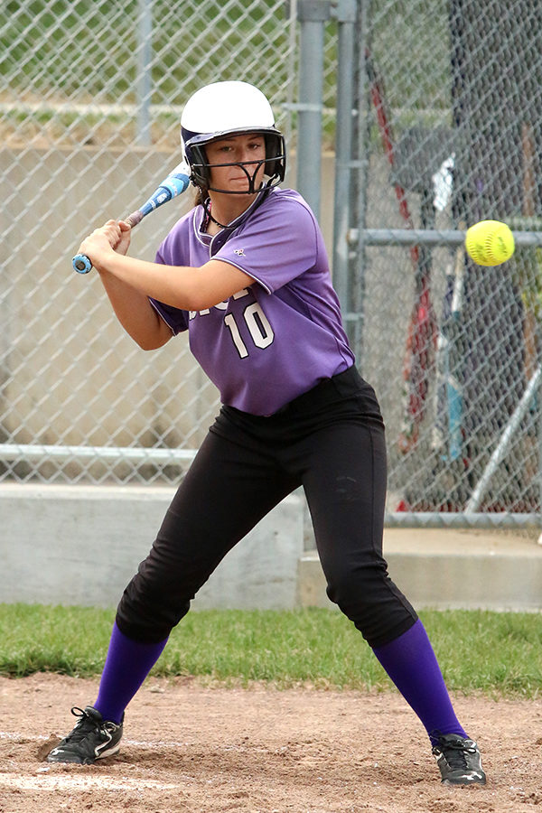 Concentrating on the softball, senior Sarah Totta prepares to swing her bat at the softball game. Overall, the storm finished their season 5-21 with a 3rd place in the Raytown South softball tournament.