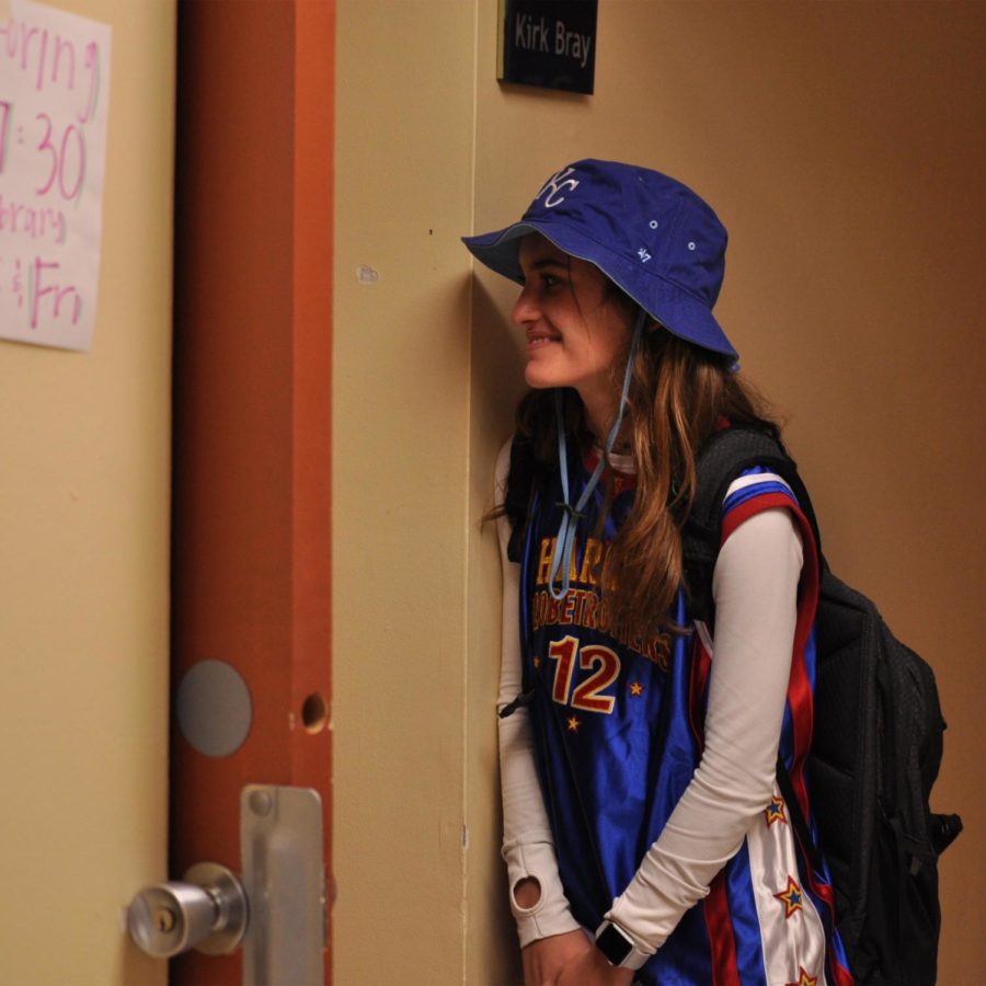 Freshman Sophia Totta peers into Latin teacher Kirk Bray’s room dressed as a boy Sept. 17. The spirit week theme was Sion School for Boys.