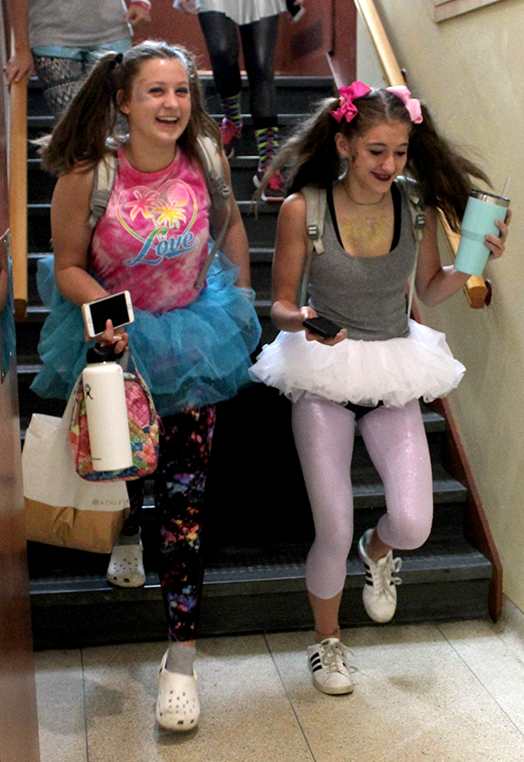 During the third day of spirit week, sophomores Mia Legato and Diana Hisle walk to lunch dressed in their Kidz Bop themed costumes Sept. 19. 