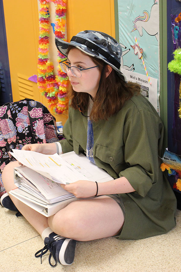 Freshman Olivia Mancina listens to her friend from acoss the freshman hallway before school on the camo-themed day of spirit week Sept. 18.