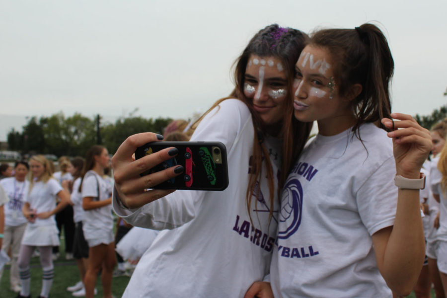 Juniors Reilly Jackoboice and Liz Jacobs take a victory selfie after the white team won the water balloon toss during field day.