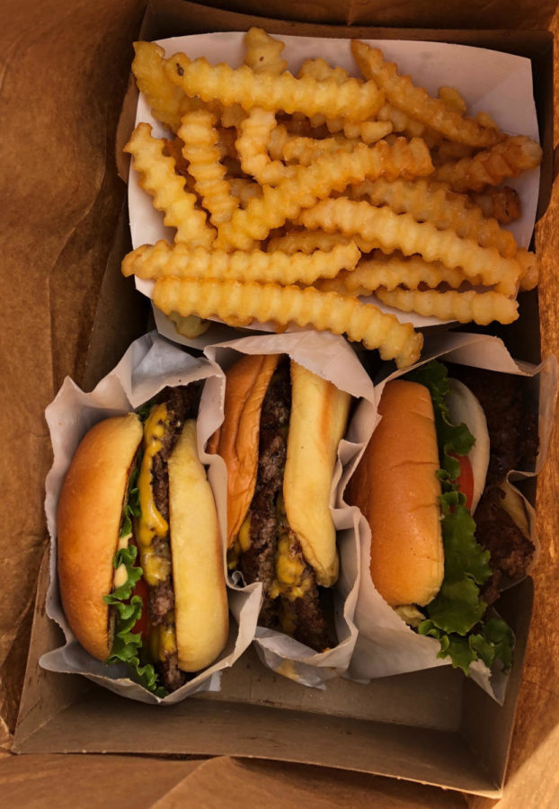 Shake Shack burgers and fries packed up to-go.