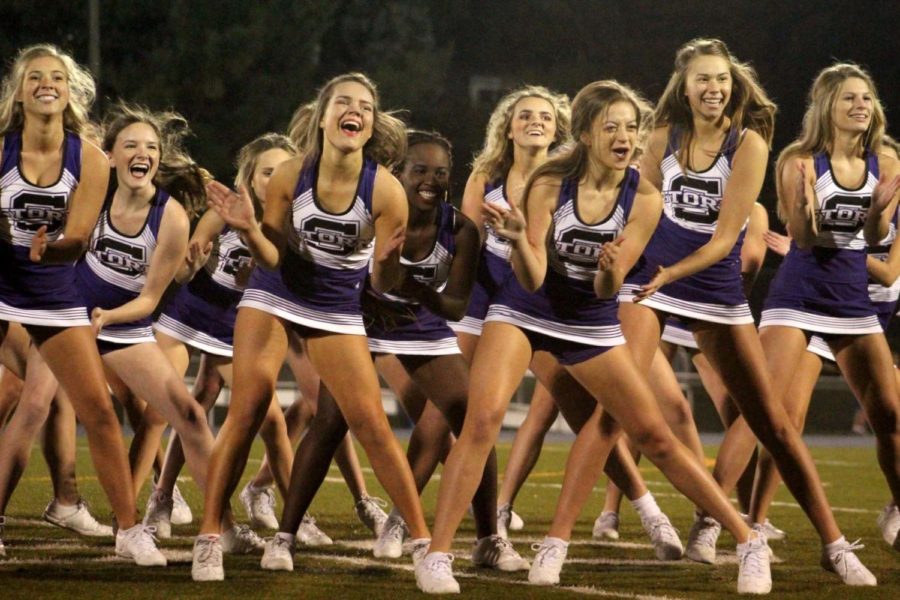 Seniors Mimi Wright, Liz Oltjen, Savannah Childress, and Lola Tebbe perform the dancing portion of the cheer routine performed at Rockhurst halftime Oct. 19. The routine was organized by the seniors, as is tradition.