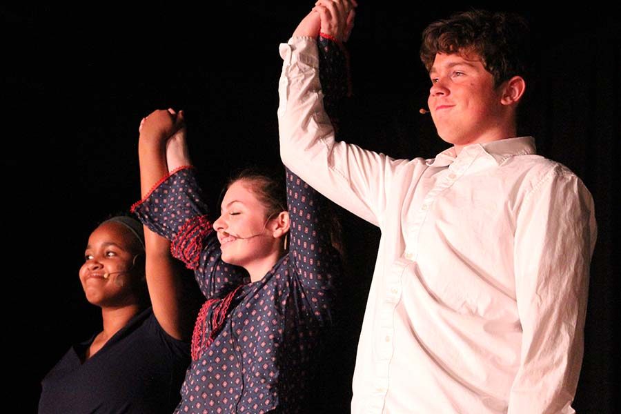 Freshmen Tyra Frazier and Olivia Mancina take a bow with Rockhurst sophomore Ian Mulkey following their performance at Night of One Acts Oct. 3.