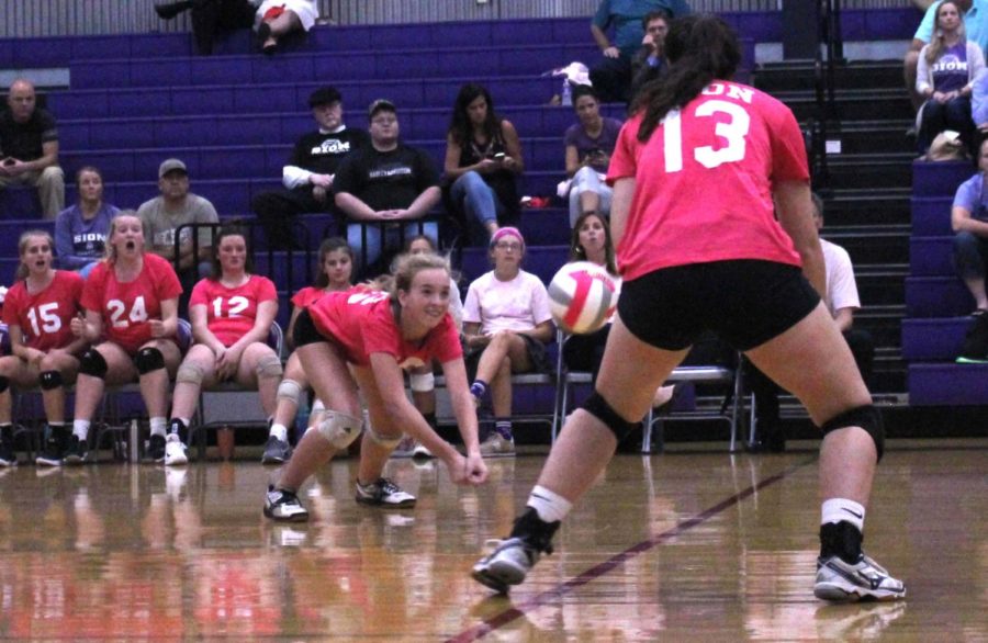 Freshman Bridgette Conner dives for the volleyball as junior Ceresa Munjak-Khoury goes to save it during the Dig Pink game Oct. 1.