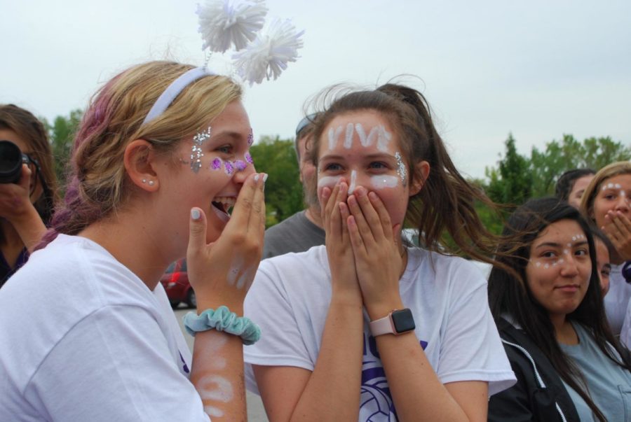 Sophomore Mikayla Gunther and junior Liz Jacobs react to junior Lily Henkle getting hit in the head by a softball thrown by sophomore Abby DeLong while she was aiming for the dunk tank at the Purple White field day Sept. 21.