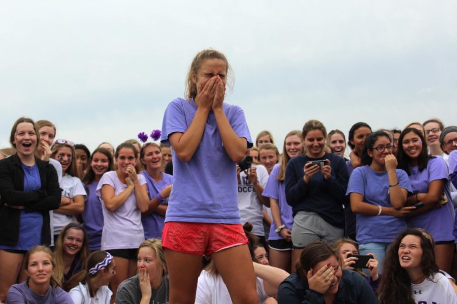 Sophomore Abby DeLong grimaces after hitting junior Lily Henkle in the head with a softball while aiming for the dunktank at the Purple White field day Sept. 22.