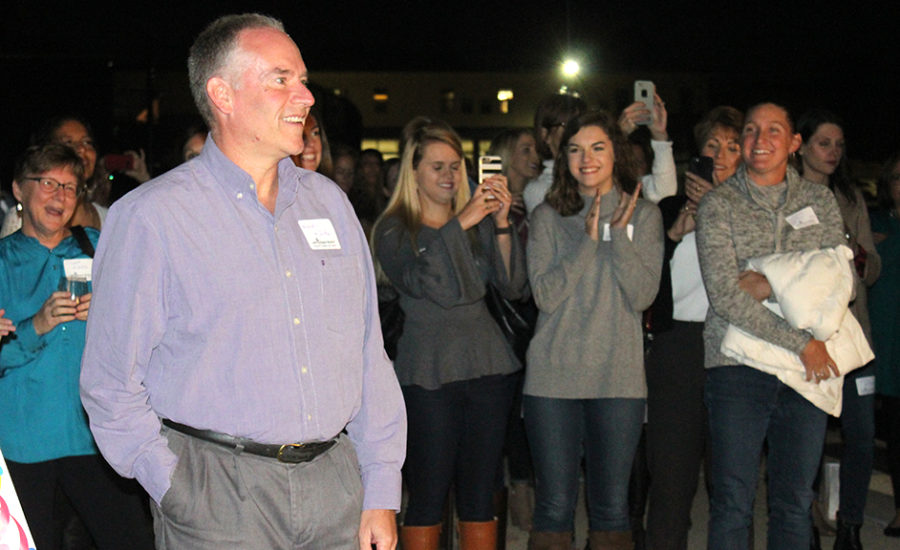 Family, coworkers and friends look on as math teacher Reynold Middleton views the press box named after him for the first time Oct. 19.