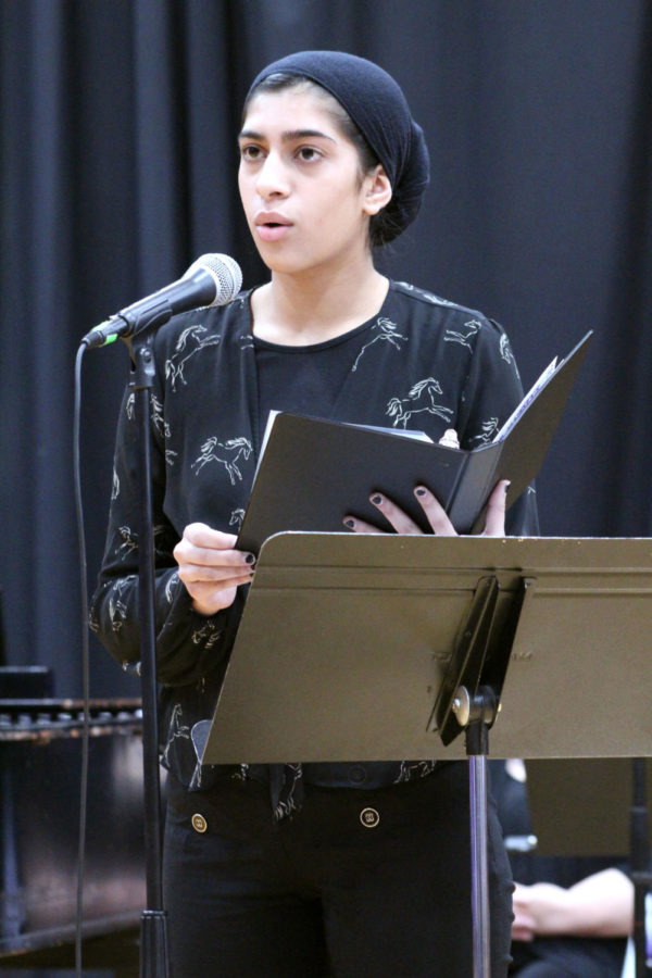 Junior Inaya Khan recites poetry at Her Majesty’s Theater Oct. 15. The theme for the night was community which was reflected in the poetry selections.