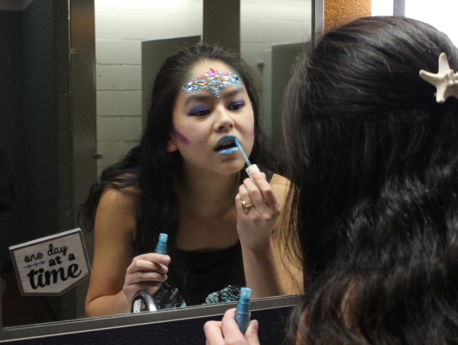 Senior Sarah White touches up her mermaid makeup in between classes for Halloween, Oct. 31. 