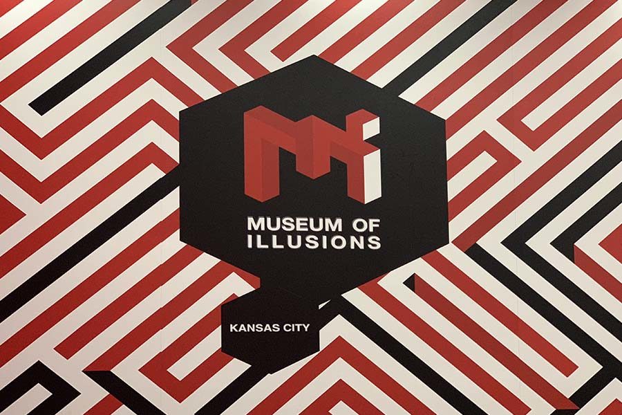 The Museum of Illusions Kansas City logo is displayed on walls throughout the museum.