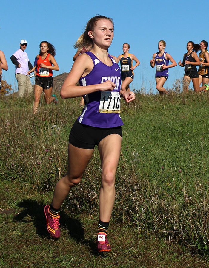 Junior Lily Henkle crosses the one mile mark during the Sectional cross country meet at the Wildflower Cross Country Course Oct. 27.