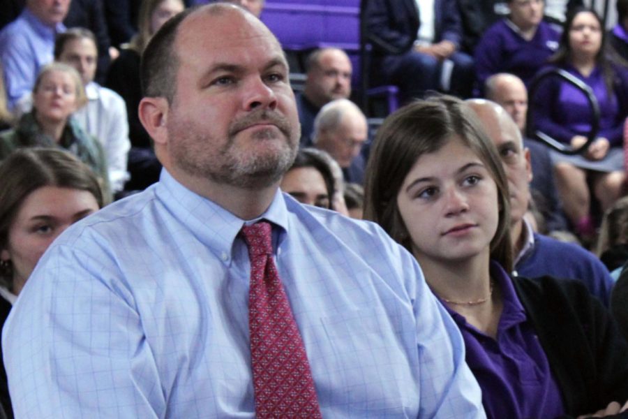 Sophomore Byrnna Dow and her dad Peter Dow sit together at the annual Father-Daughter Mass Nov. 1 in the gym. Father’s were invited to attend the Mass that happens each year on All Saints Day.