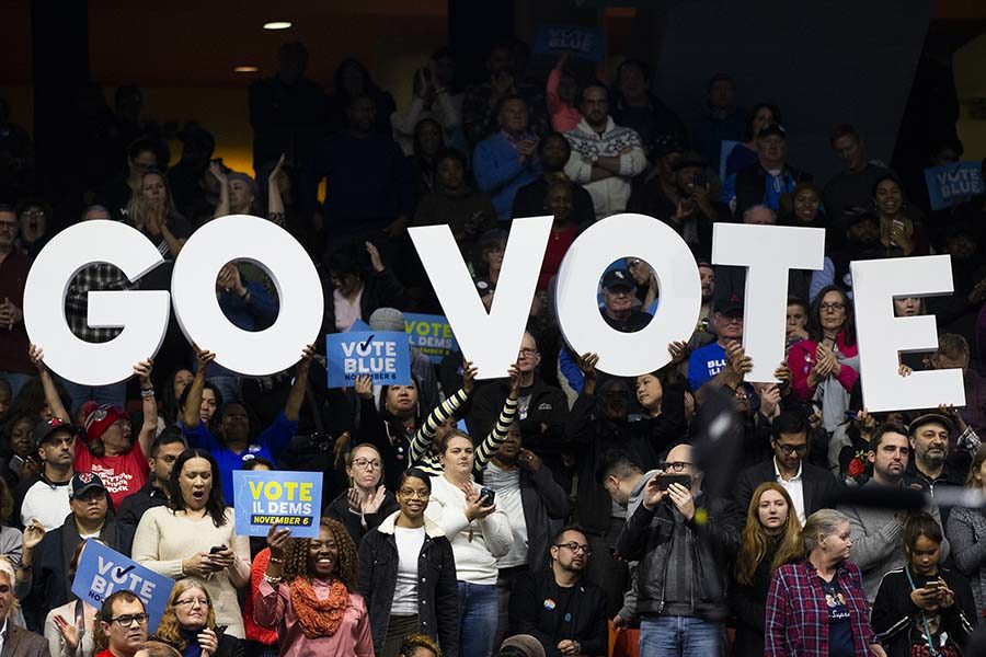 Attendees hold up a "Go Vote" sign during a get-out-the-vote rally with former President Barack Obama, gubernatorial candidate J.B. Pritzker and other members of the Illinois Democratic ticket on Sunday, Nov. 4, 2018 at the UIC Pavilion in Chicago, Ill. (Armando L. Sanchez/Chicago Tribune/TNS)