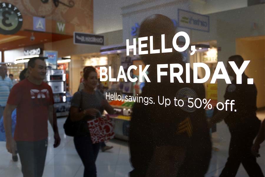 Stores advertise Black Friday sales to draw the attention of shoppers on Thanksgiving, Thursday, Nov. 24, 2016 at Dolphins Mall. Shoppers headed to the mall for their holiday shopping and savings. 