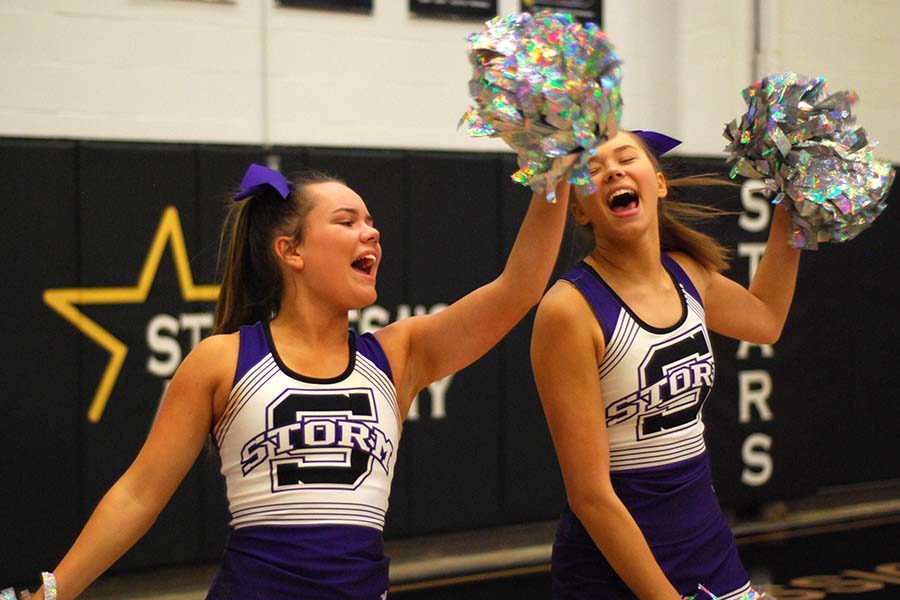 Senior cheer captainLiz Oltjen and senior co-captain Lola Tebbe dance during half time of the basketball game against St. Teresa’s Academy Dec. 4.