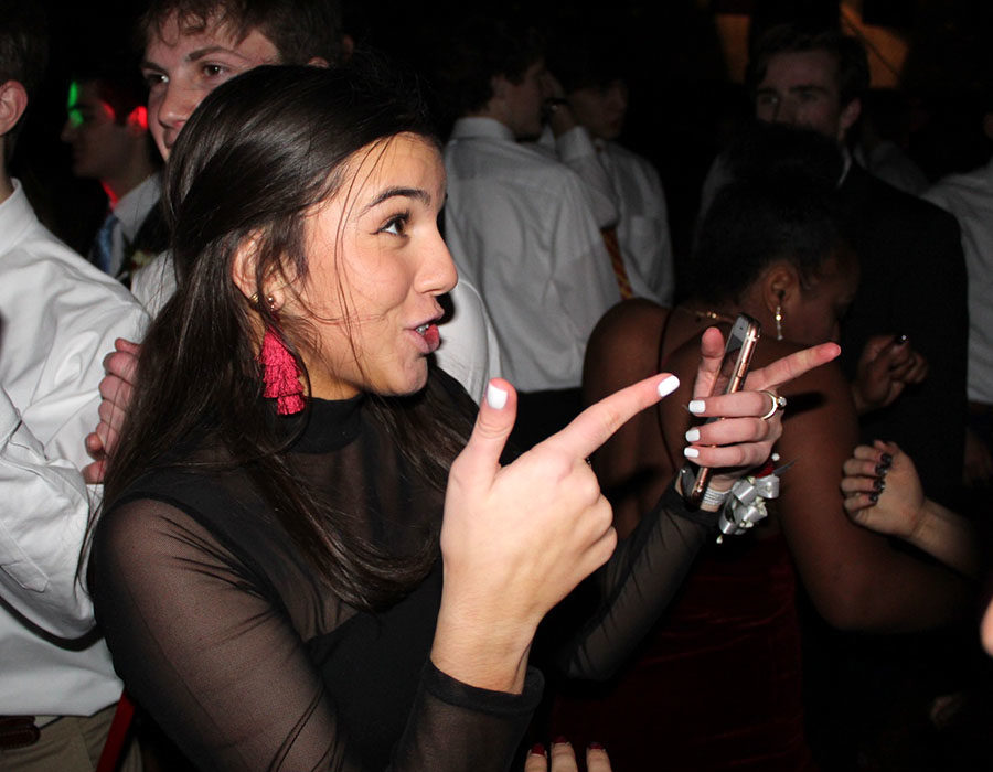 Junior Sophia Angrisano points to one of her friends on the dance floor at Winter Formal Dec. 1.