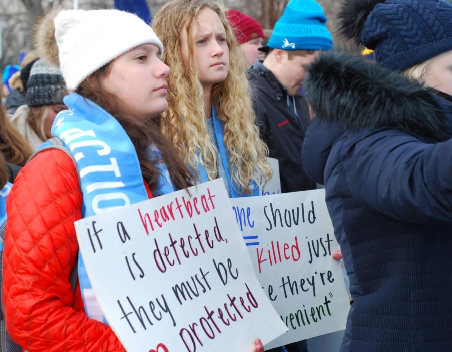 In Washington D.C. for the March for Life Jan. 18, sophomores Morgan Herriott and Olivia Overlease carry homemade signs. Students carried both homemade signs and premade ones handed out by various groups on the march.