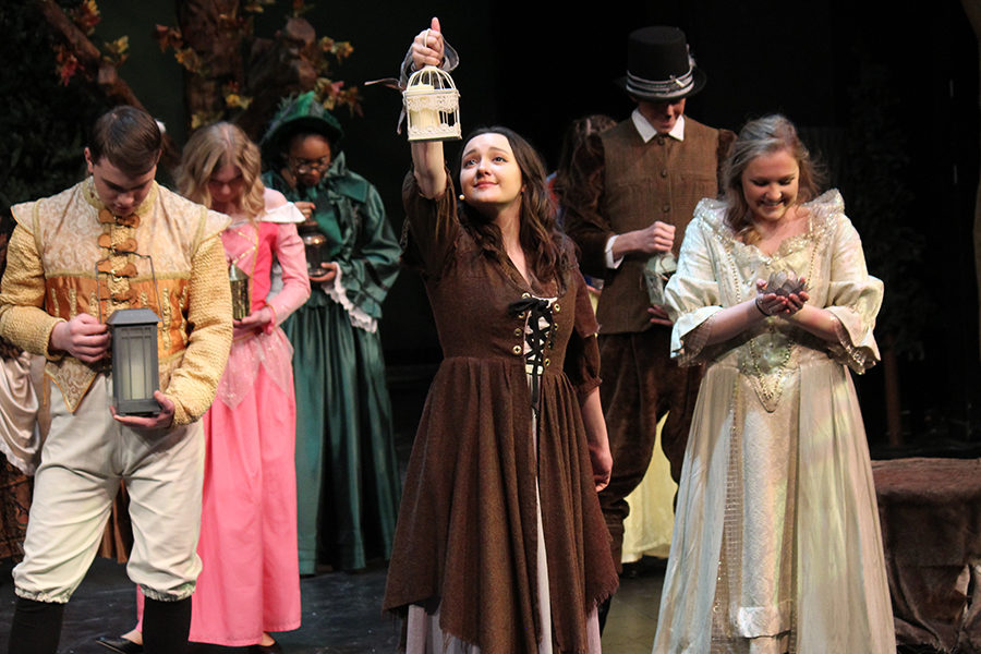 During act one of “Into the Woods," Cinderella played by senior Jordan Harrison follows the light of her lantern into the woods. 