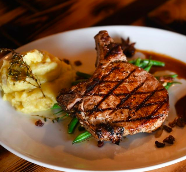 The main entree from Blind Box BBQ, a participator in Kansas City Restaurant Week, which consists of a wood-fired pork chop, seasonal vegetables, and mashed potatoes. 